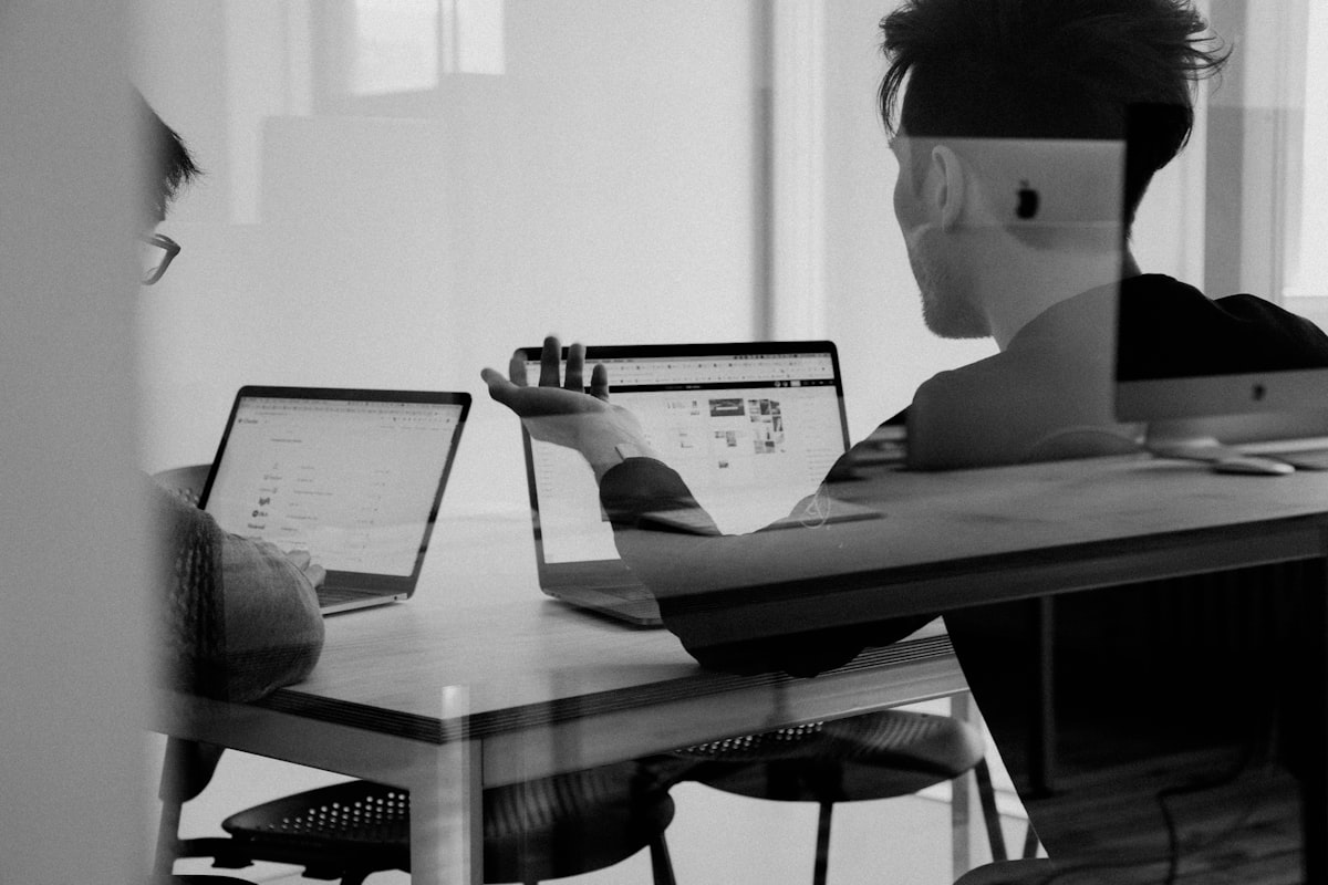 Developers collaborating on custom software at a whiteboard