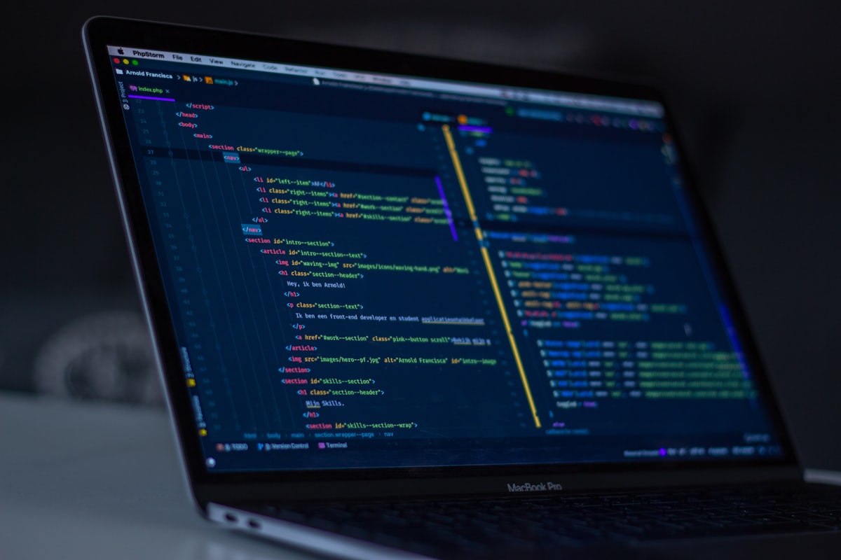 Developer writing code on a laptop